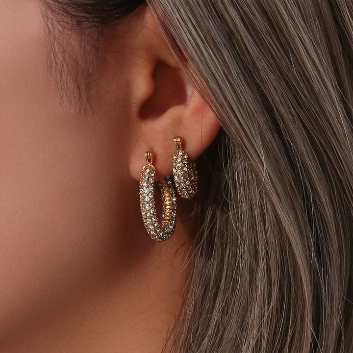 Gold pave hoop earrings shown on model worn with smaller pair of hoops to show double earring look